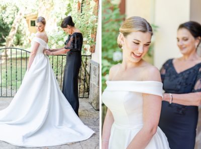 bride gets into classic wedding dress with mom