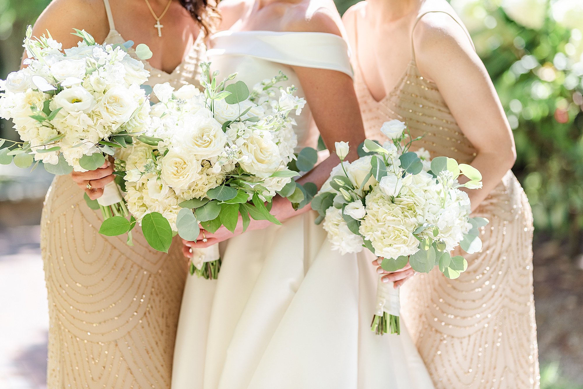 all-white bouquets for bride and bridesmaids