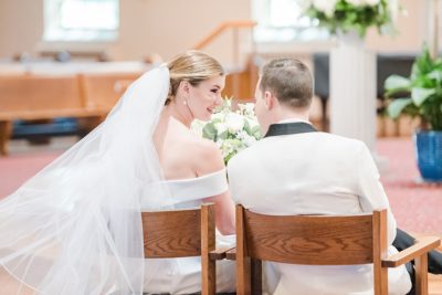 bride and groom whisper during wedding ceremony in Ohio