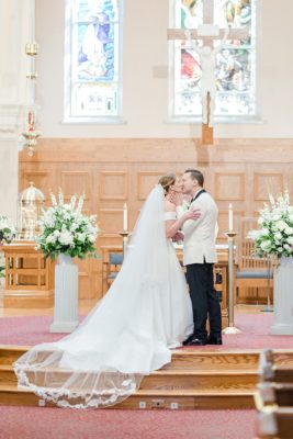 newlyweds kiss at alter in church