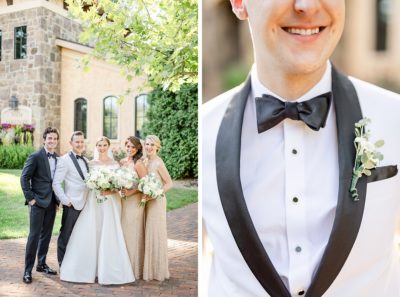 groom in white tux poses with bride and bridesmaids