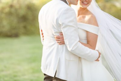 bride hugs groom during portraits at Gervasi Vineyard