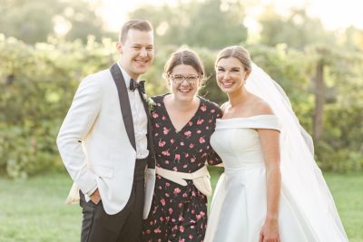 Stephanie Kase Photography poses with bride and groom at Gervasi Vineyard