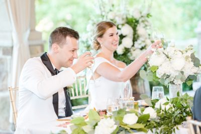 bride lifts wine glass during toast at Ohio wedding reception