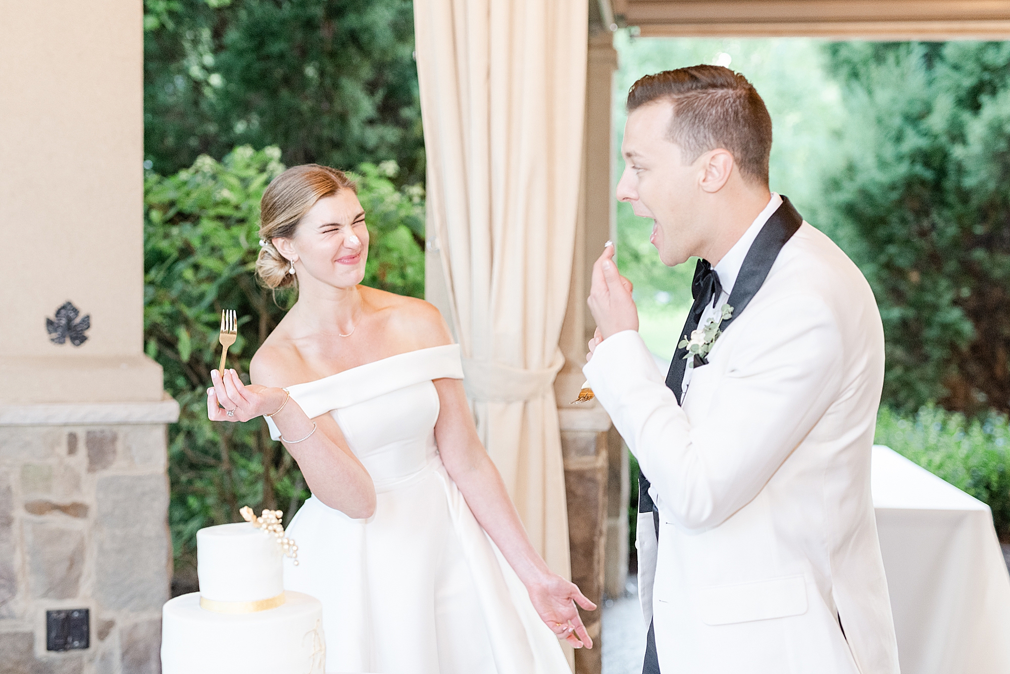 bride and groom laugh during cake cutting
