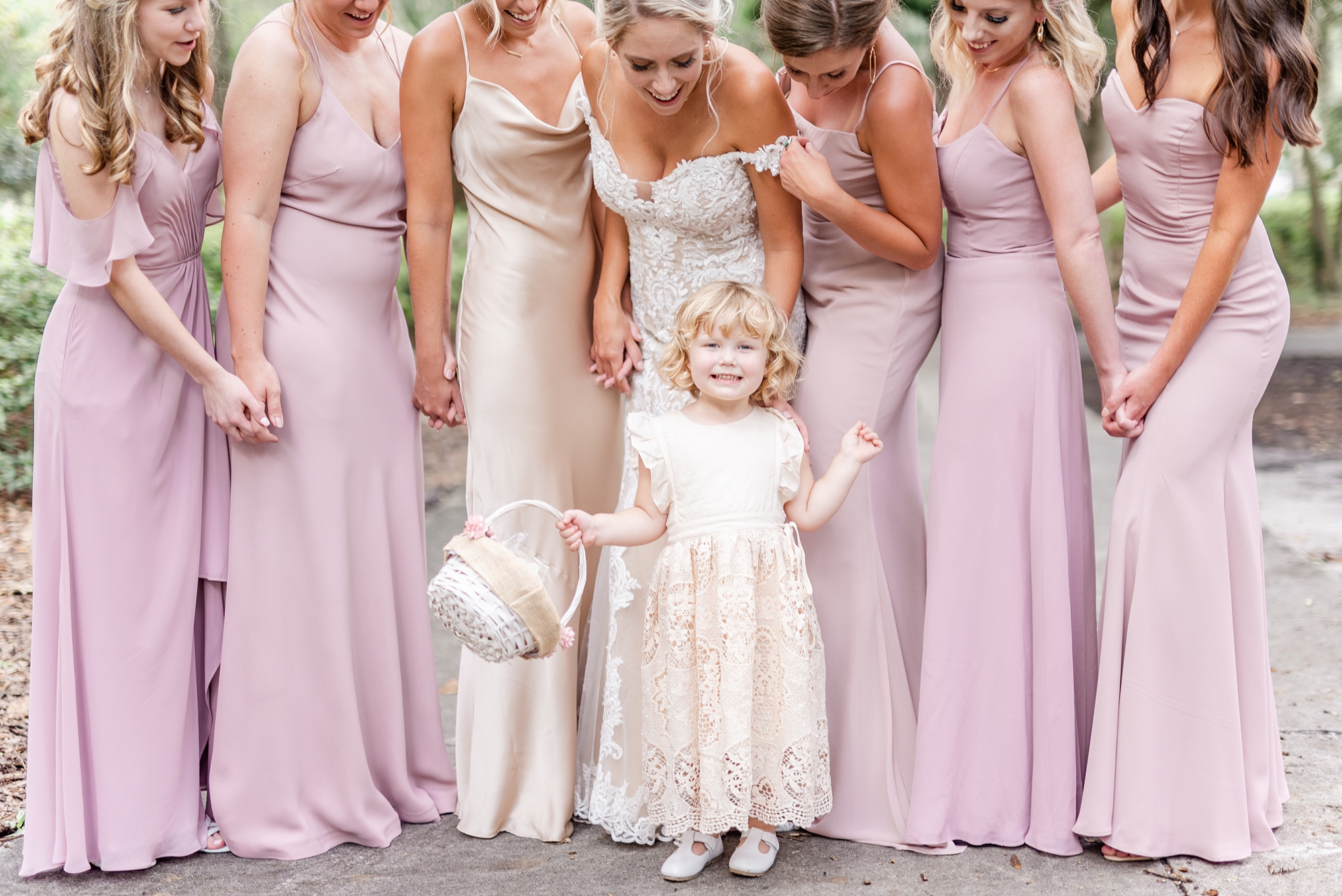 flower girl poses with bridesmaids in Savannah GA