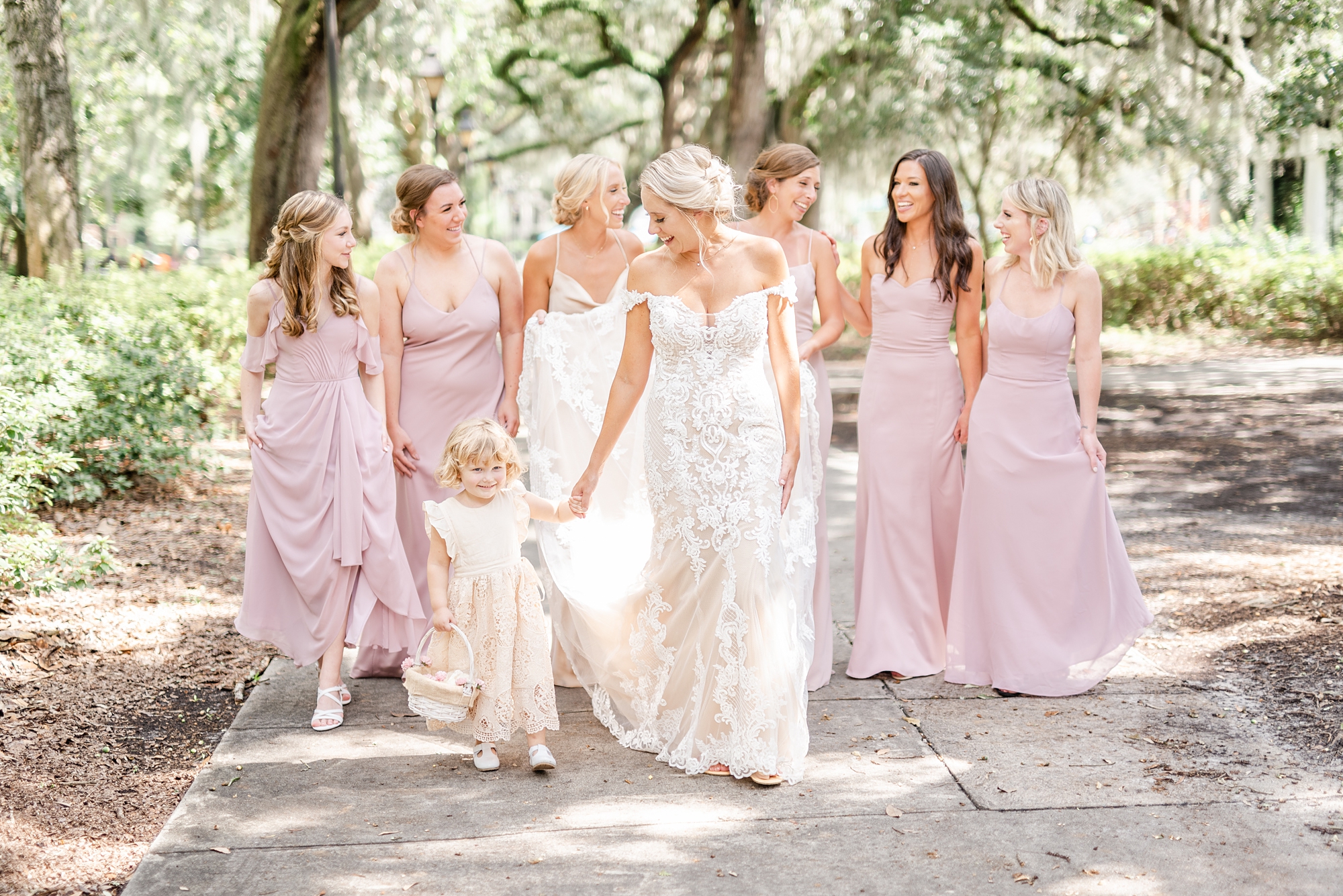 bride walks with bridesmaids under spanish moss