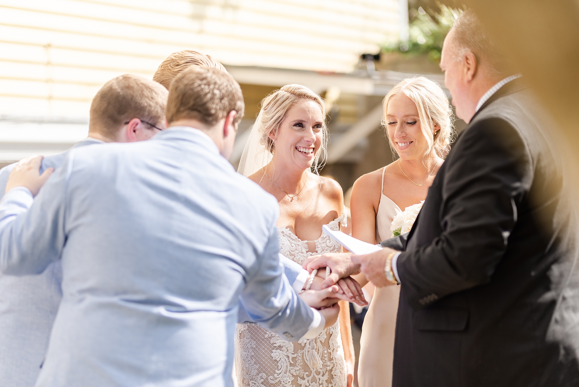 family gives bride away during wedding ceremony