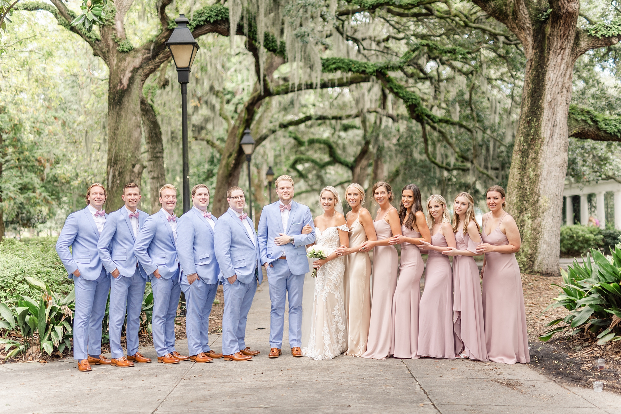 Savannah GA wedding party poses under Spanish moss