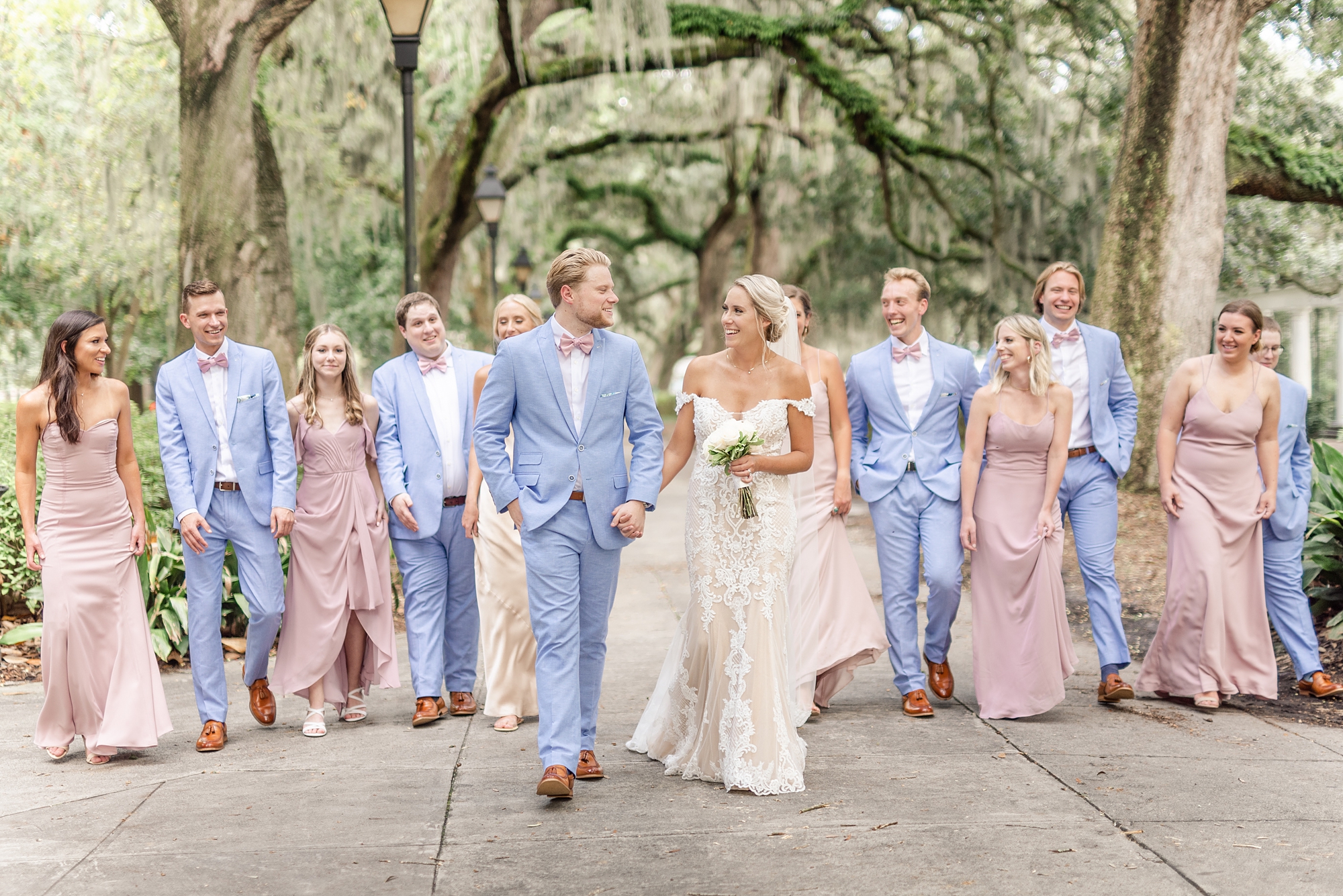 bride and groom walk with wedding party in Savannah GA