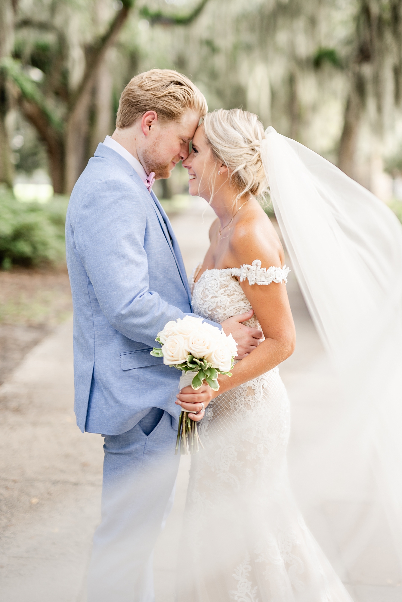 newlyweds touch foreheads during downtown Savannah GA wedding photos