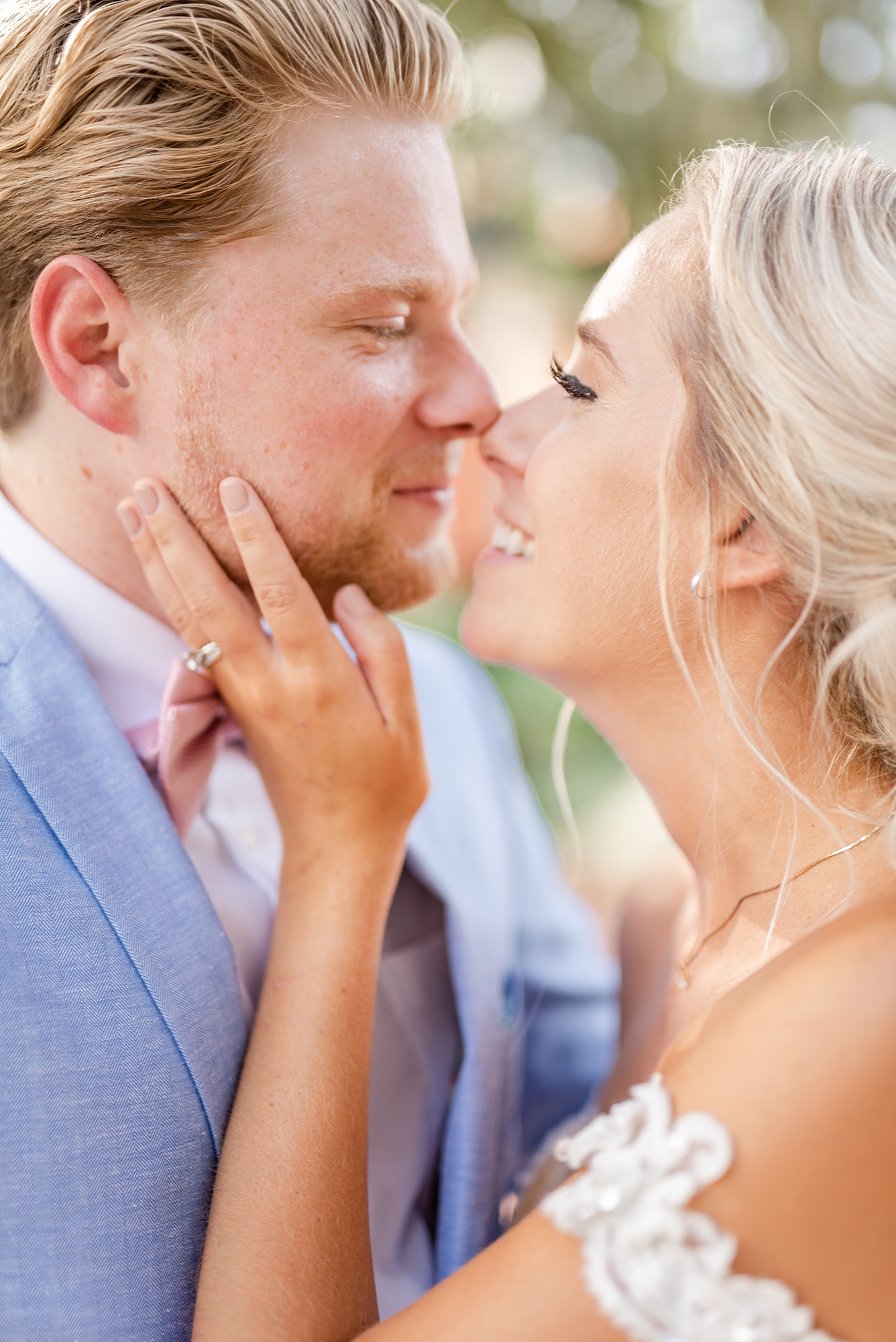 bride holds groom's cheek during Savannah GA wedding photos