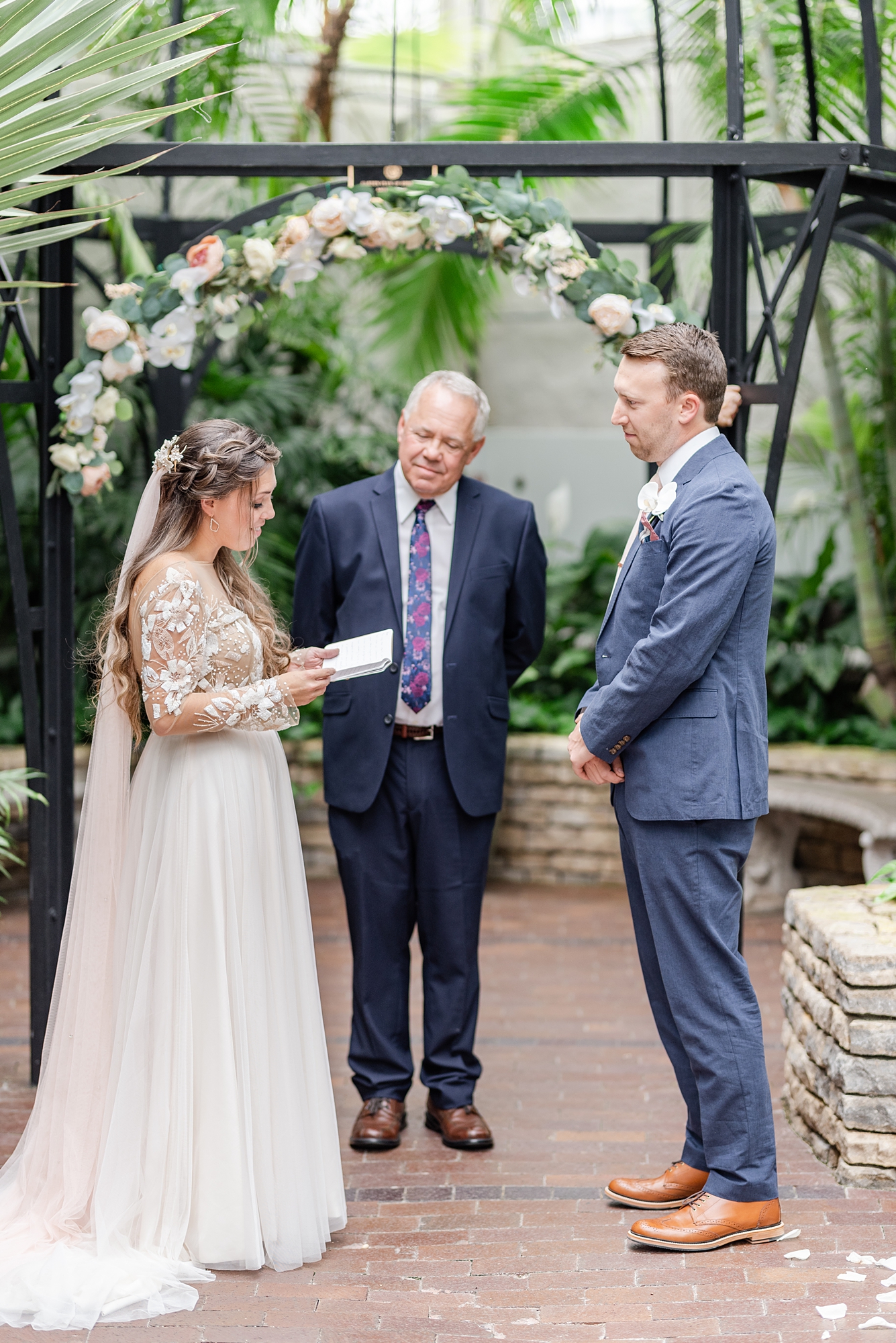 bride and groom exchange vows during Franklin Park Conservatory wedding