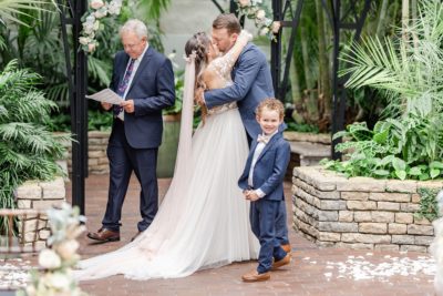 son smiles at family during first kiss