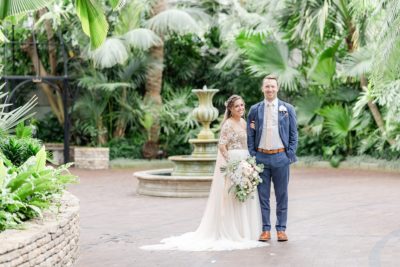 bride and groom pose in gardens at Franklin Park Conservatory
