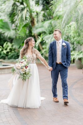 bride and groom walk through Franklin Park Conservatory
