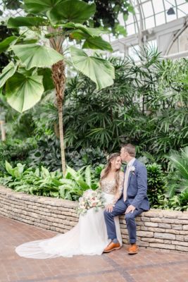 groom kisses bride's forehead during intimate wedding photos