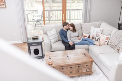 married couple poses on couch for first anniversary portraits