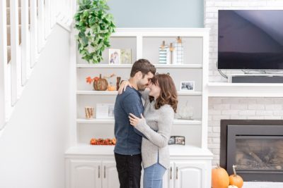 Ohio couple poses in front of shelving in living room