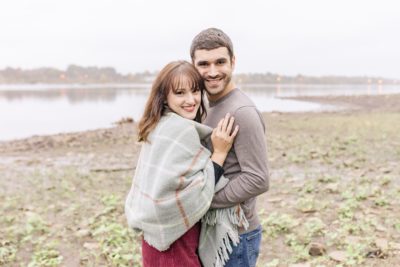 couple poses by lake in Ohio during first anniversary portraits