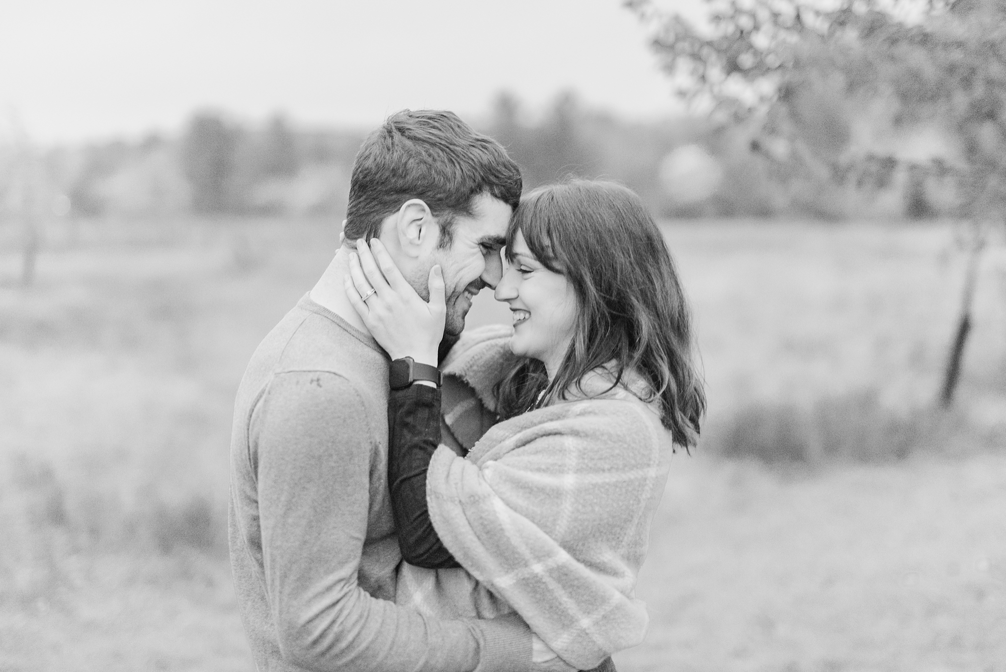 husband and wife stand nose to nose during first anniversary portraits