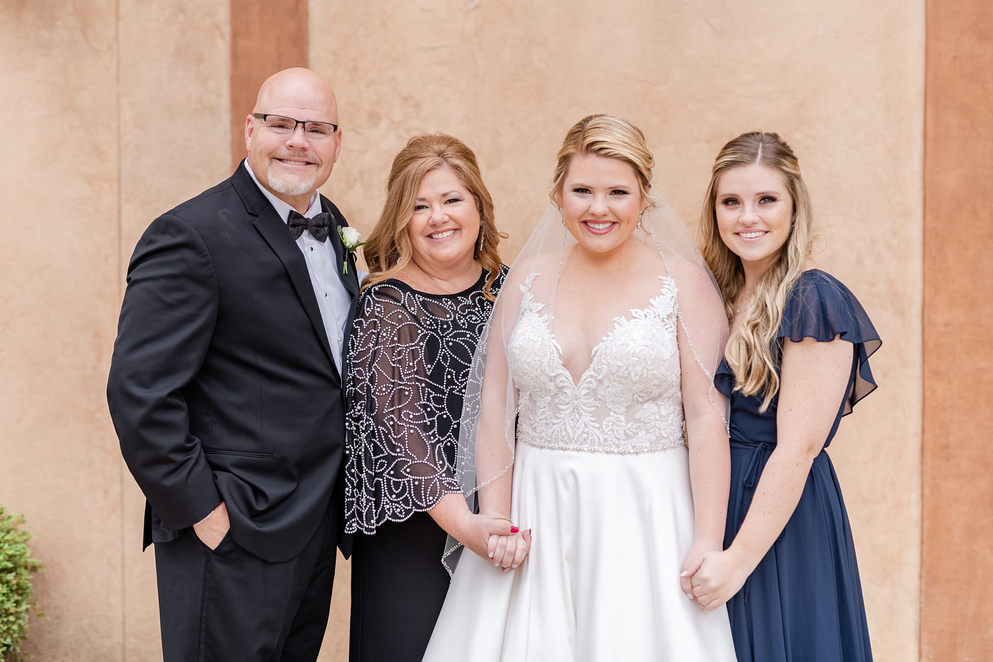 bride poses with family during Ohio wedding