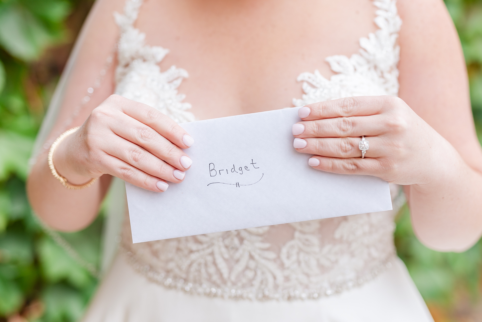 bride holds envelope from groom