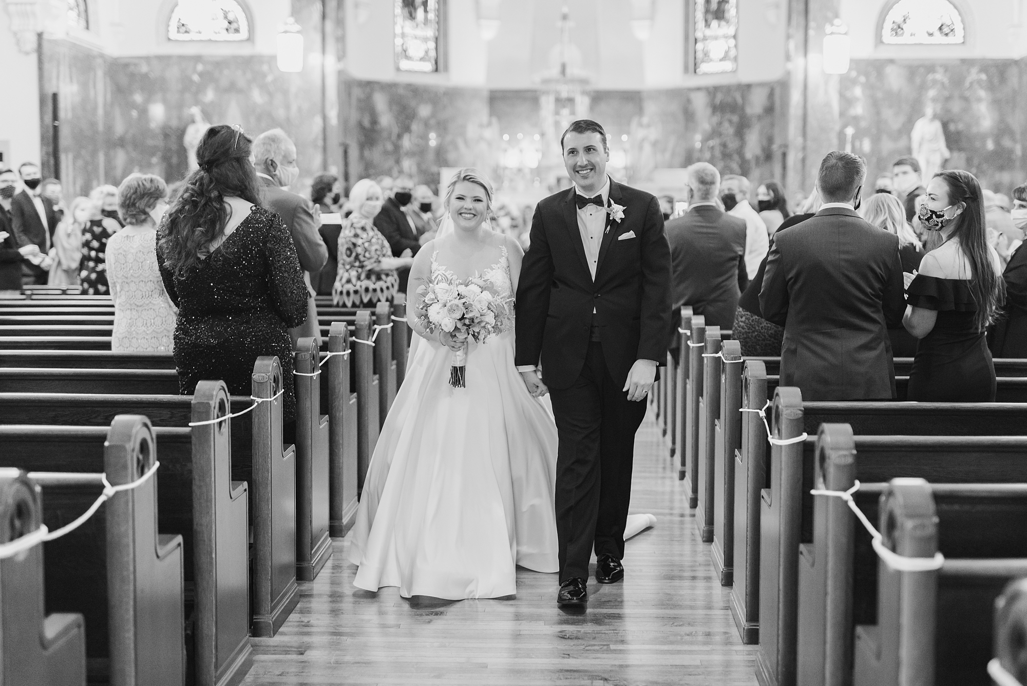 newlyweds walk up aisle at traditional church wedding in Dublin OH