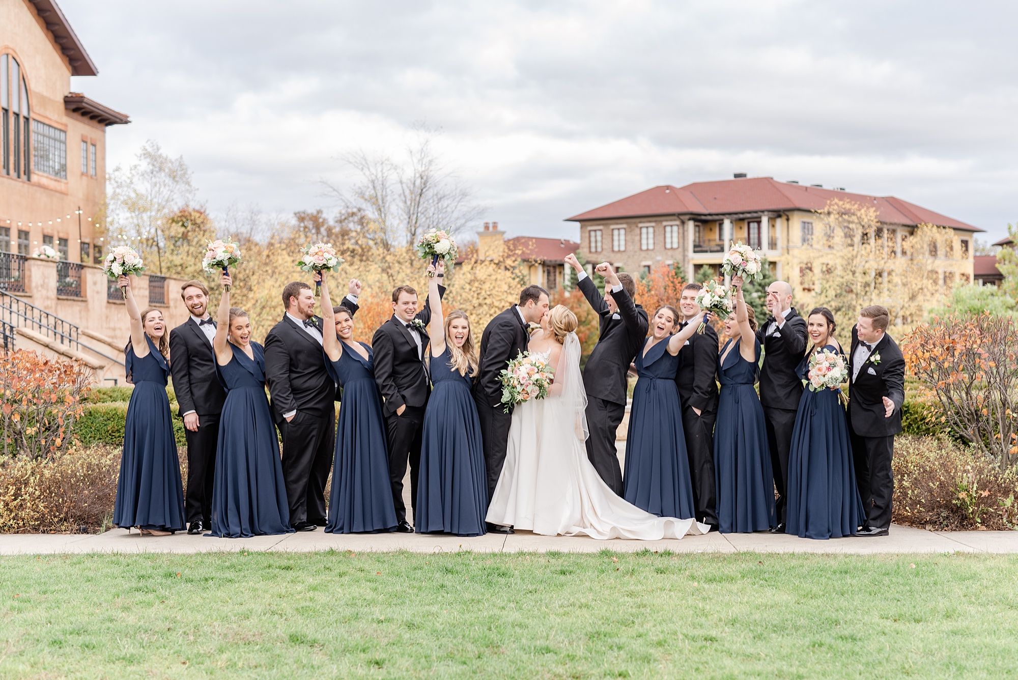 bridesmaids and groomsmen cheer for bride and groom