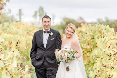 bride and groom pose in vines at The Club at Corazon