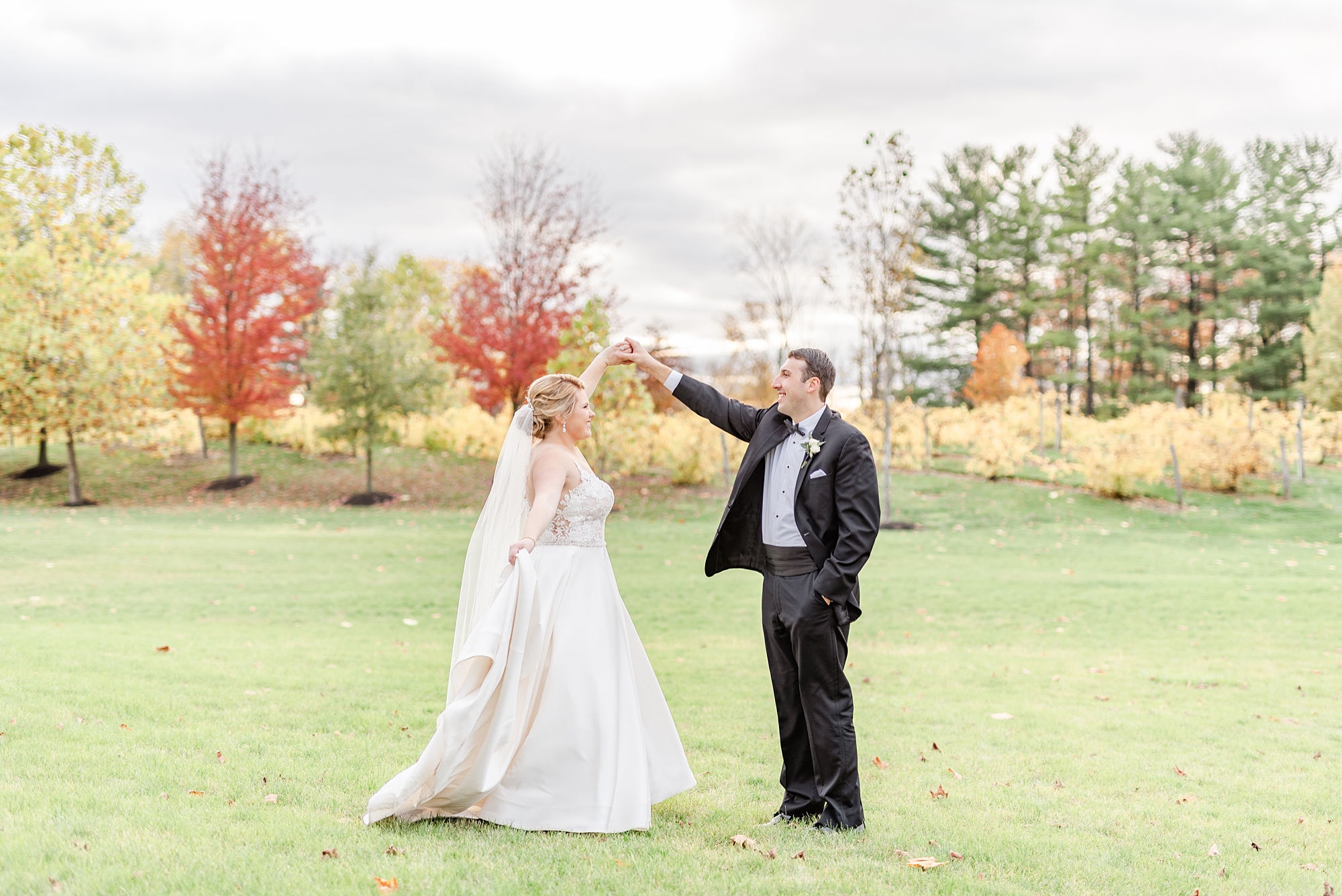 groom twirls bride during wedding photos in Ohio