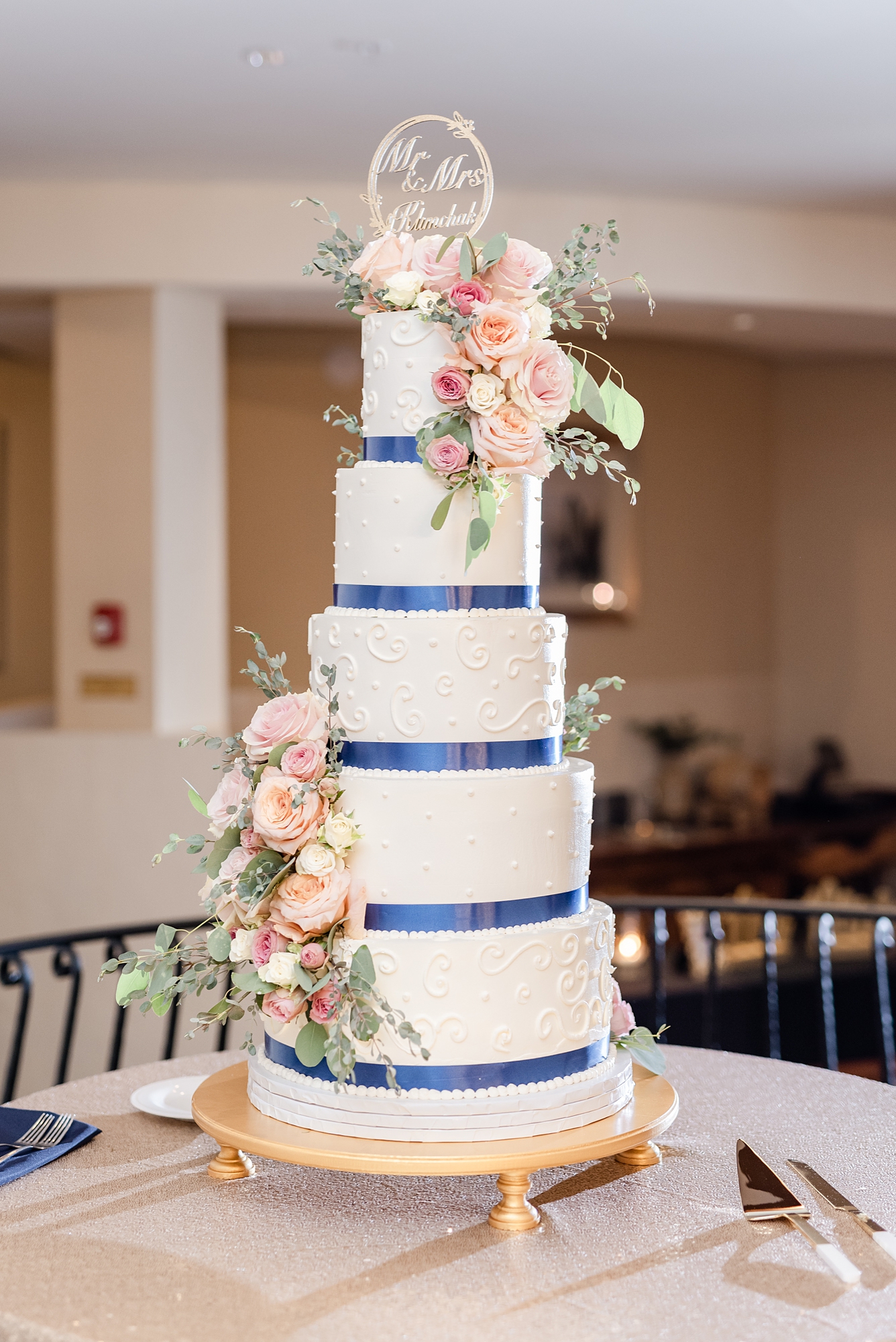 tiered wedding cake with blue ribbon