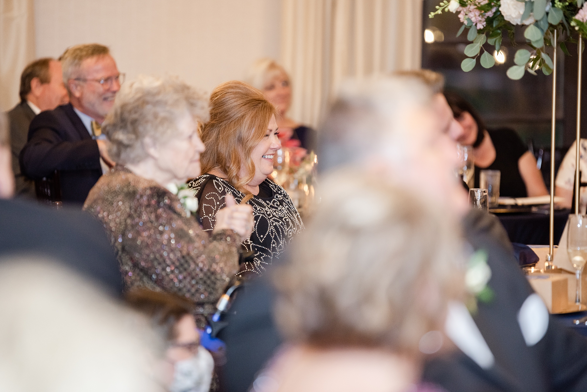 family claps during wedding toasts