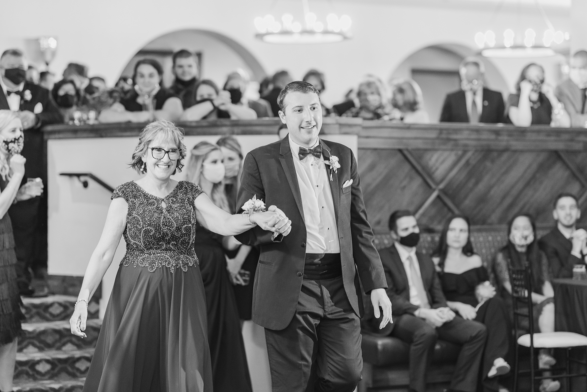 groom leads mom to dance floor
