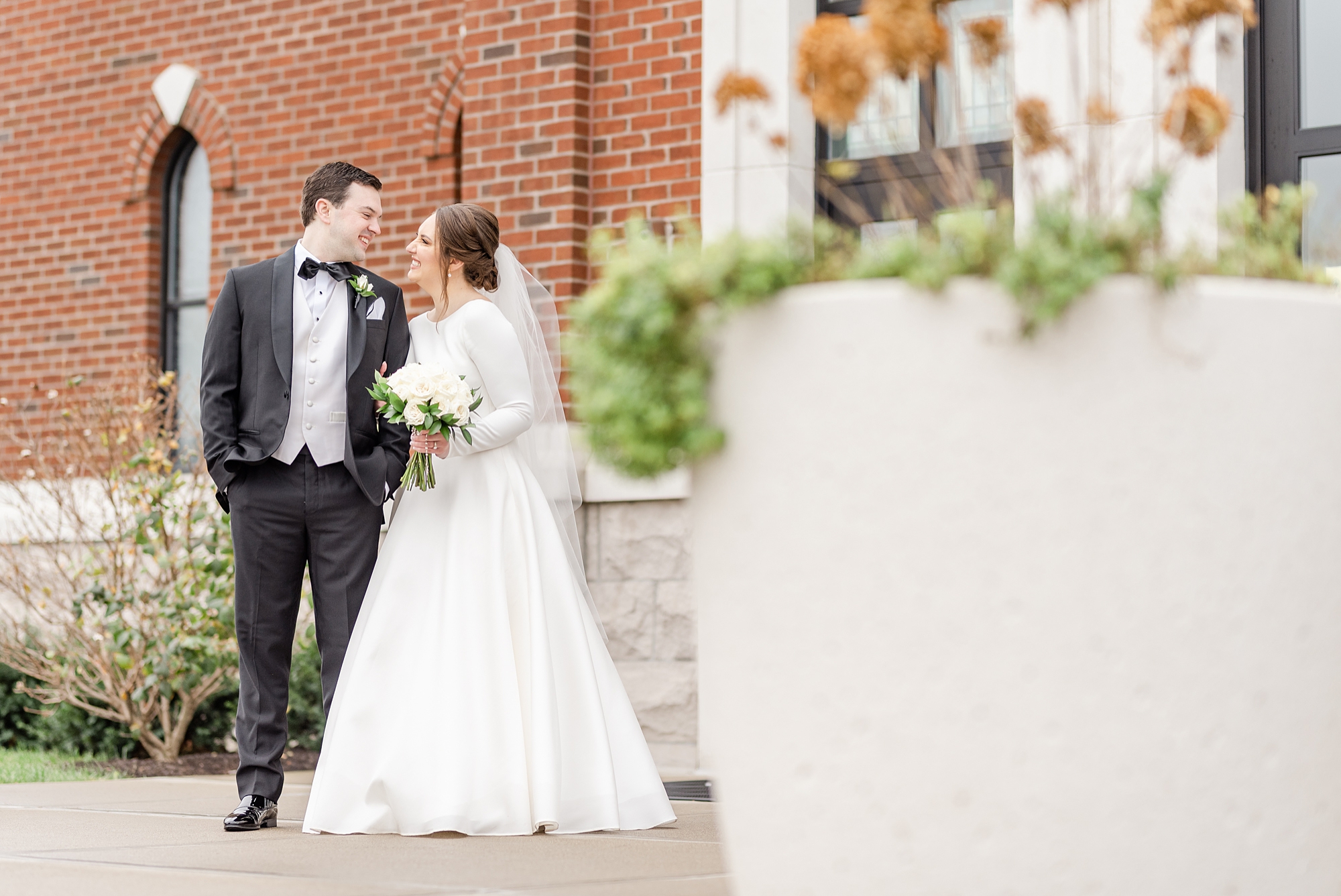 bride and groom pose outside Dayton Ohio church