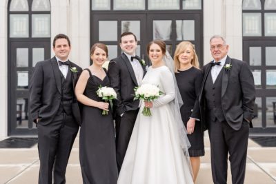 family poses with bride and groom