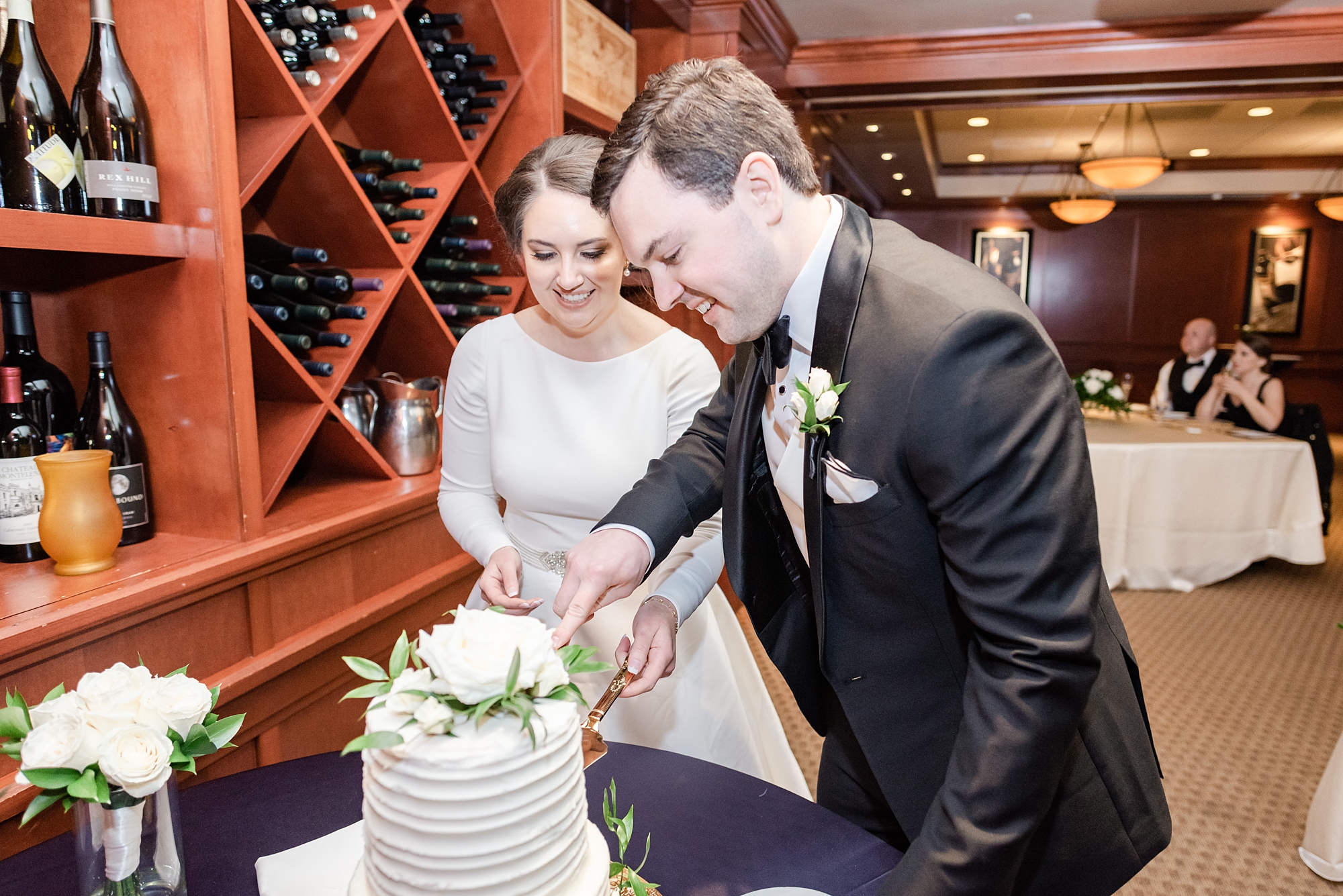 newlyweds cut wedding cake during Ohio wedding reception