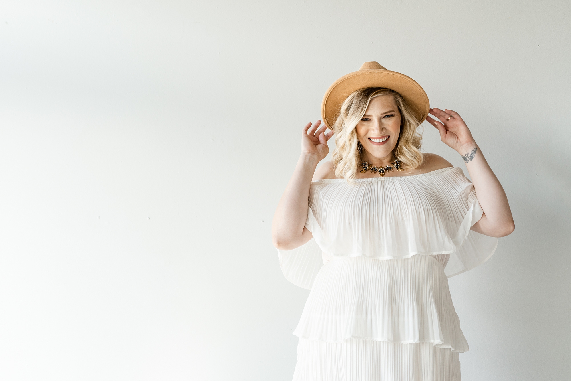 branding session with photographer in wide brimmed hat 