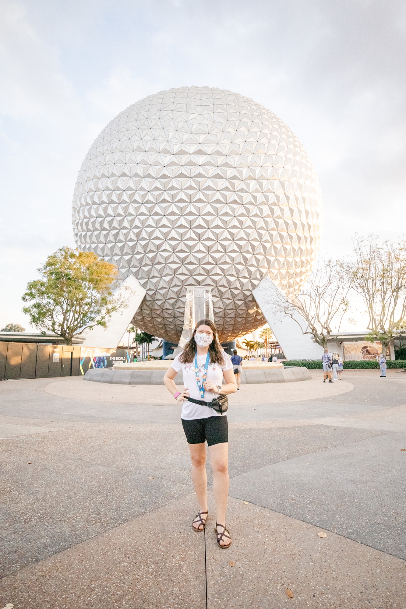 woman poses in front of Spaceship Earth