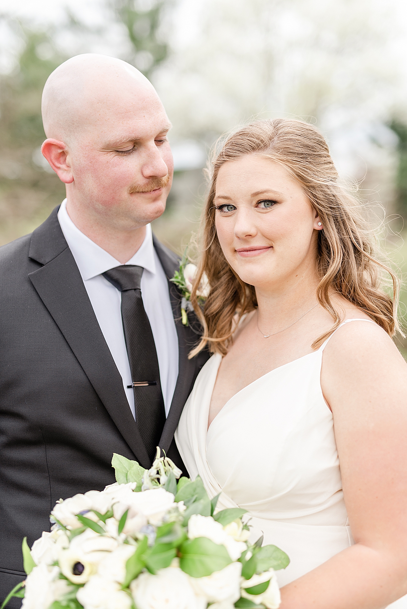 bride and groom smile together during The Estate at New Albany wedding