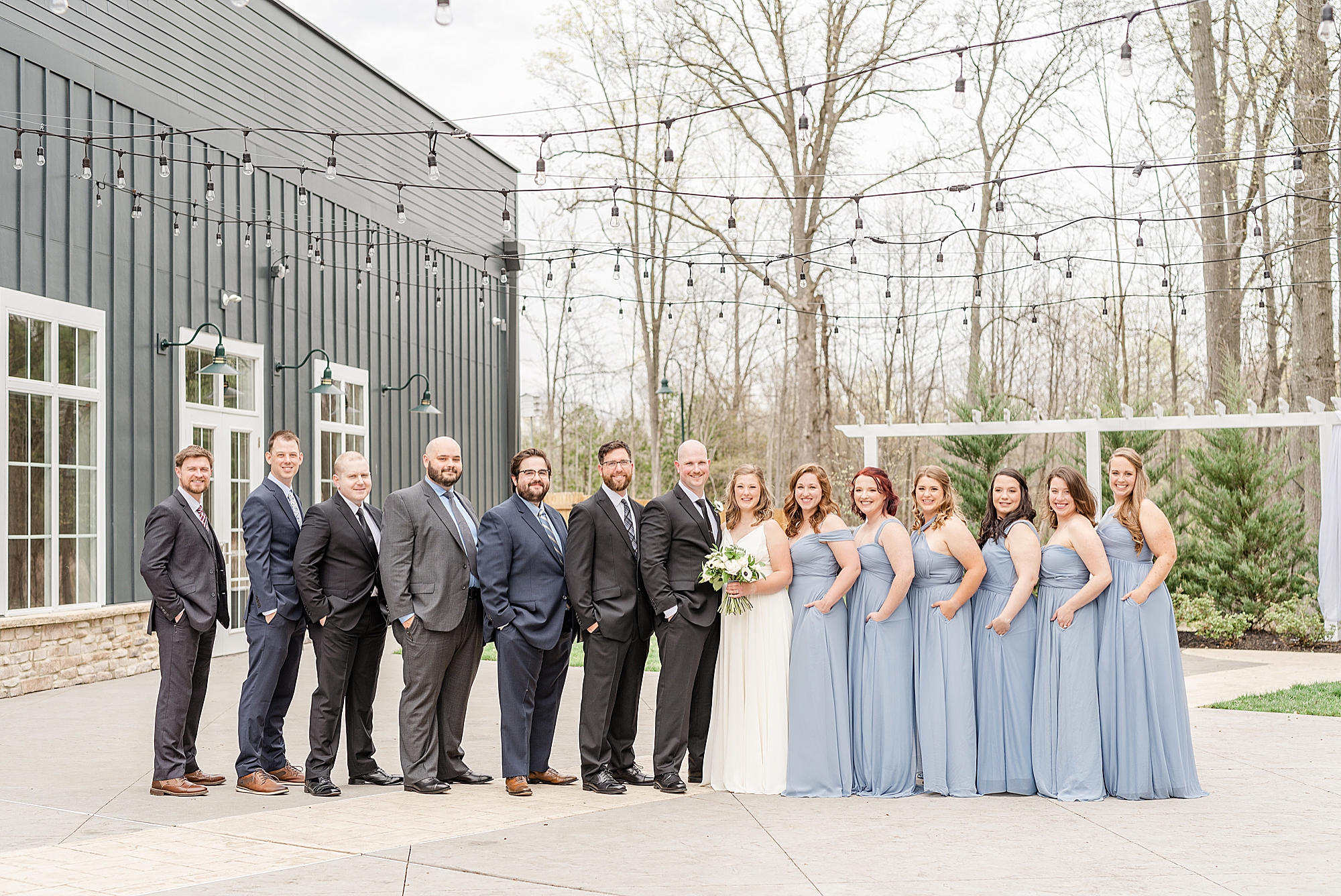 full bridal party poses outside The Estate at New Albany during spring wedding