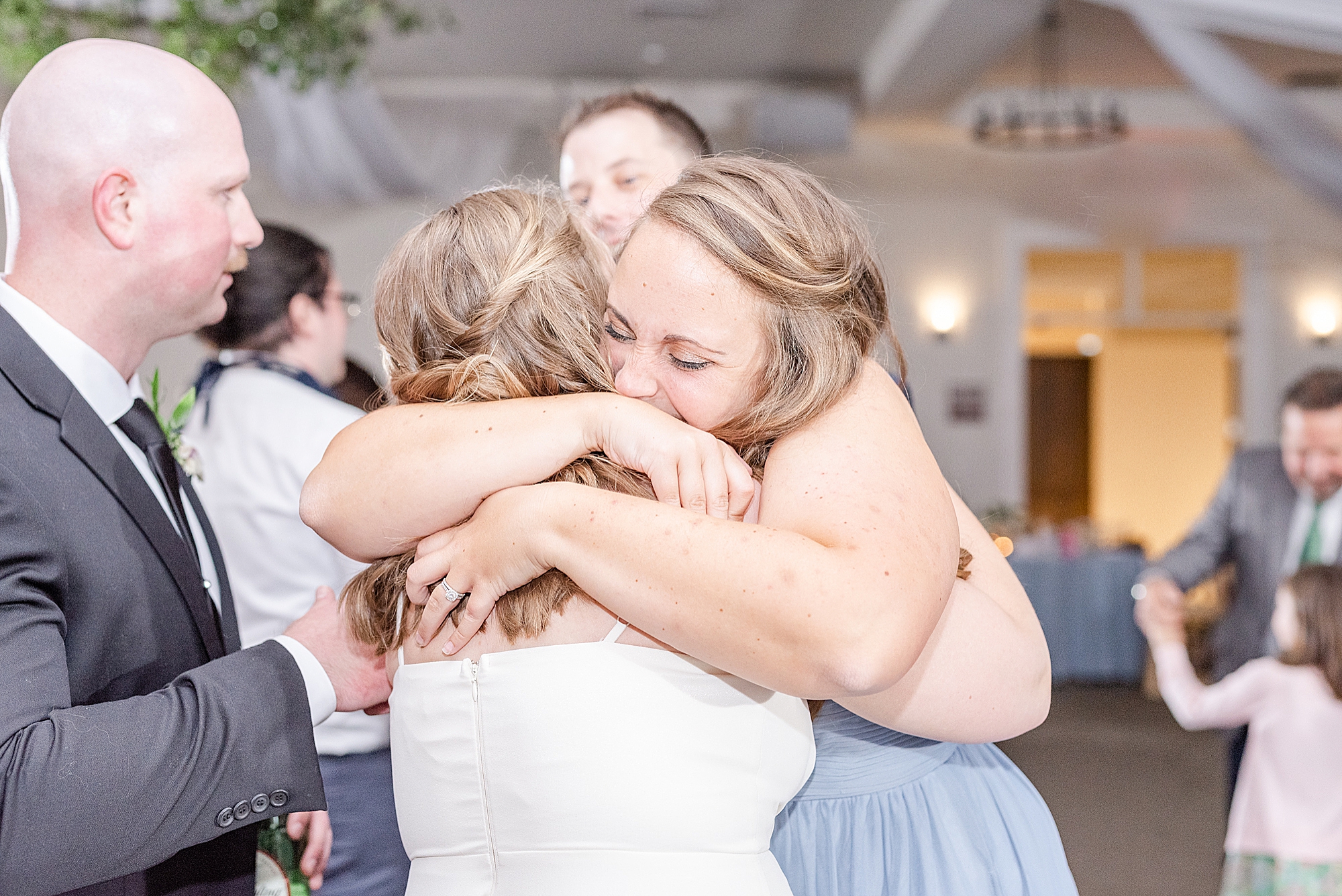 bride hugs guest during intimate wedding at the Estate at New Albany