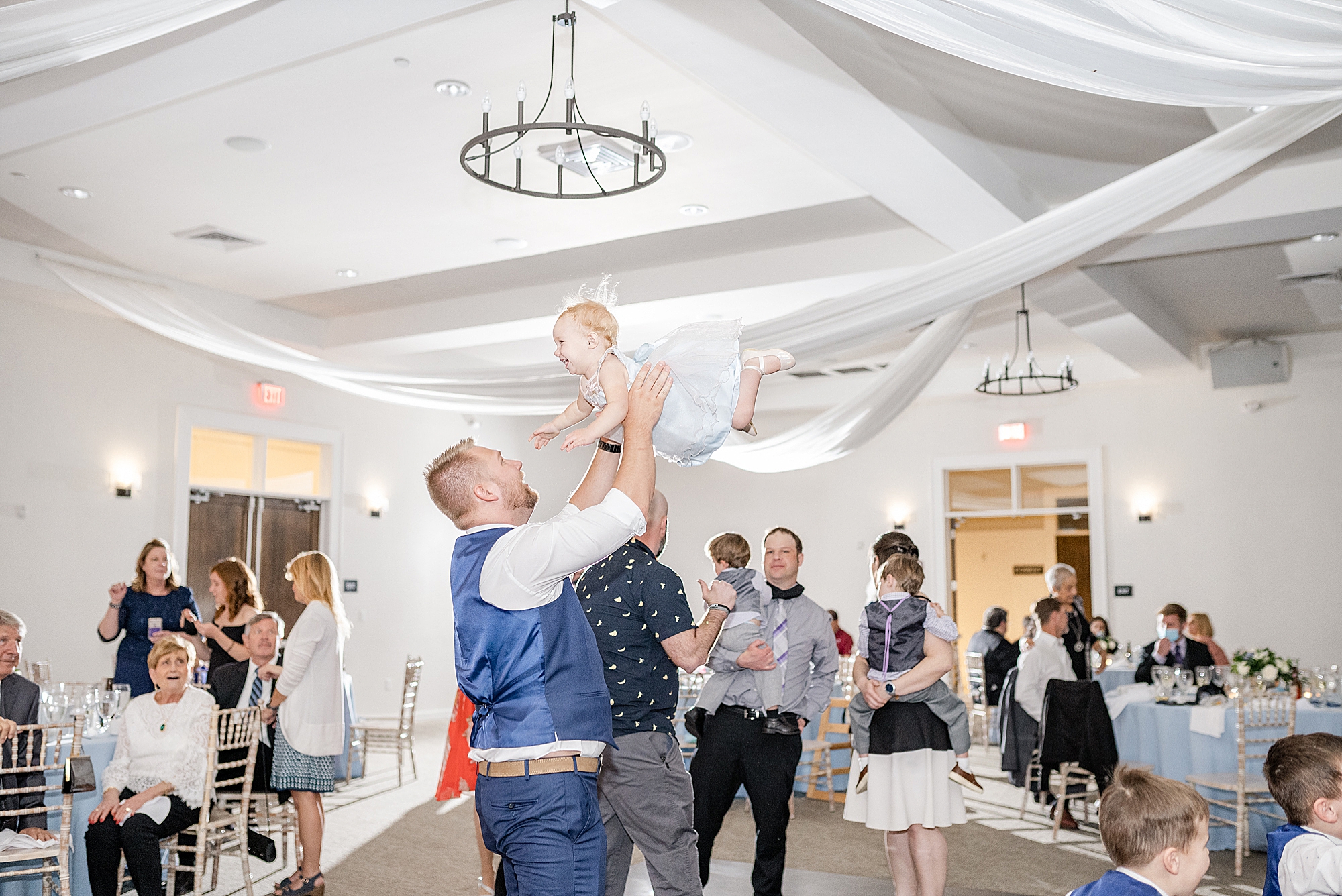 groomsman lifts child on dance floor in Ohio