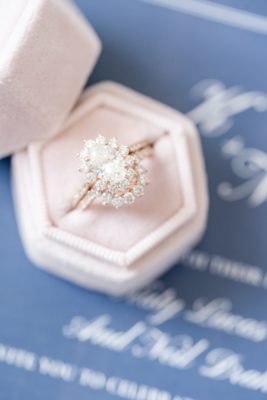 bride's engagement ring sits in pastel pink ring box