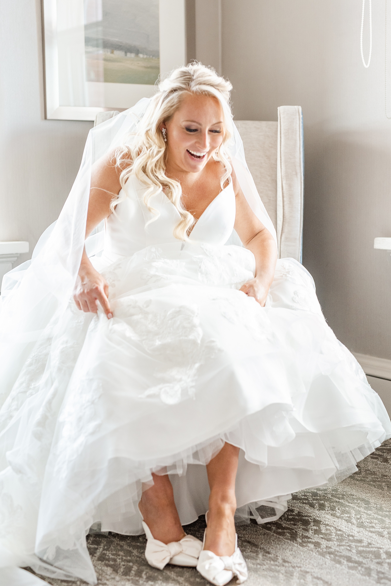 bride puts on white shoes before High Line Car House wedding