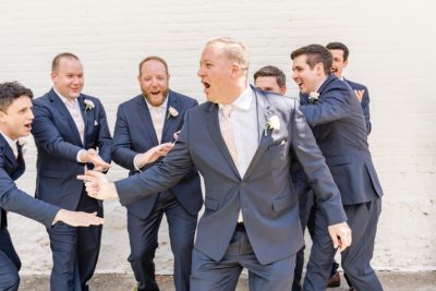 groom laughs with groomsmen in Ohio