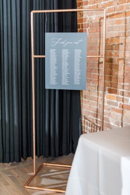 modern seating chart on copper stand