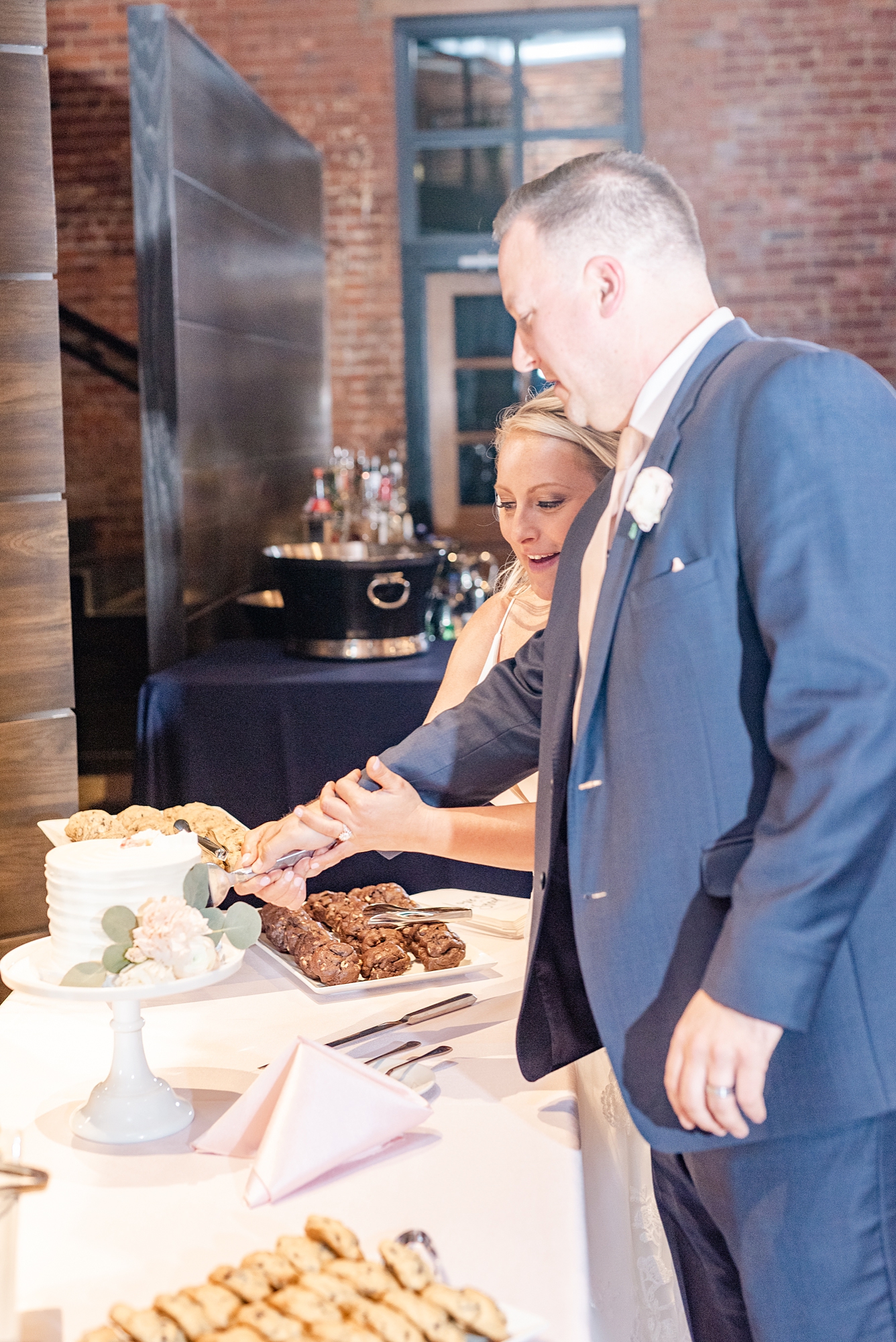 bride and groom cut wedding cake during Ohio wedding reception