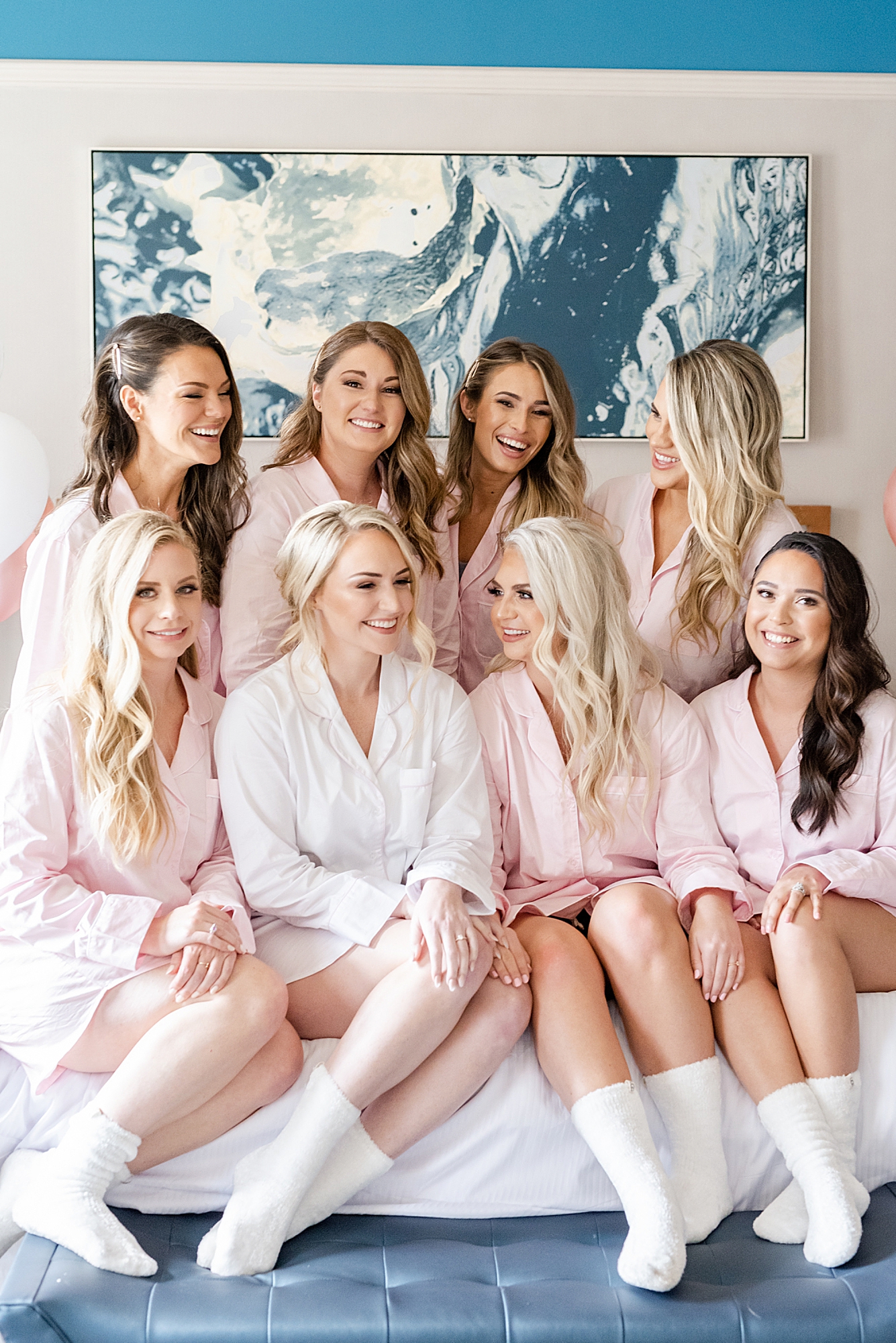 bride and bridesmaids sit in matching robes