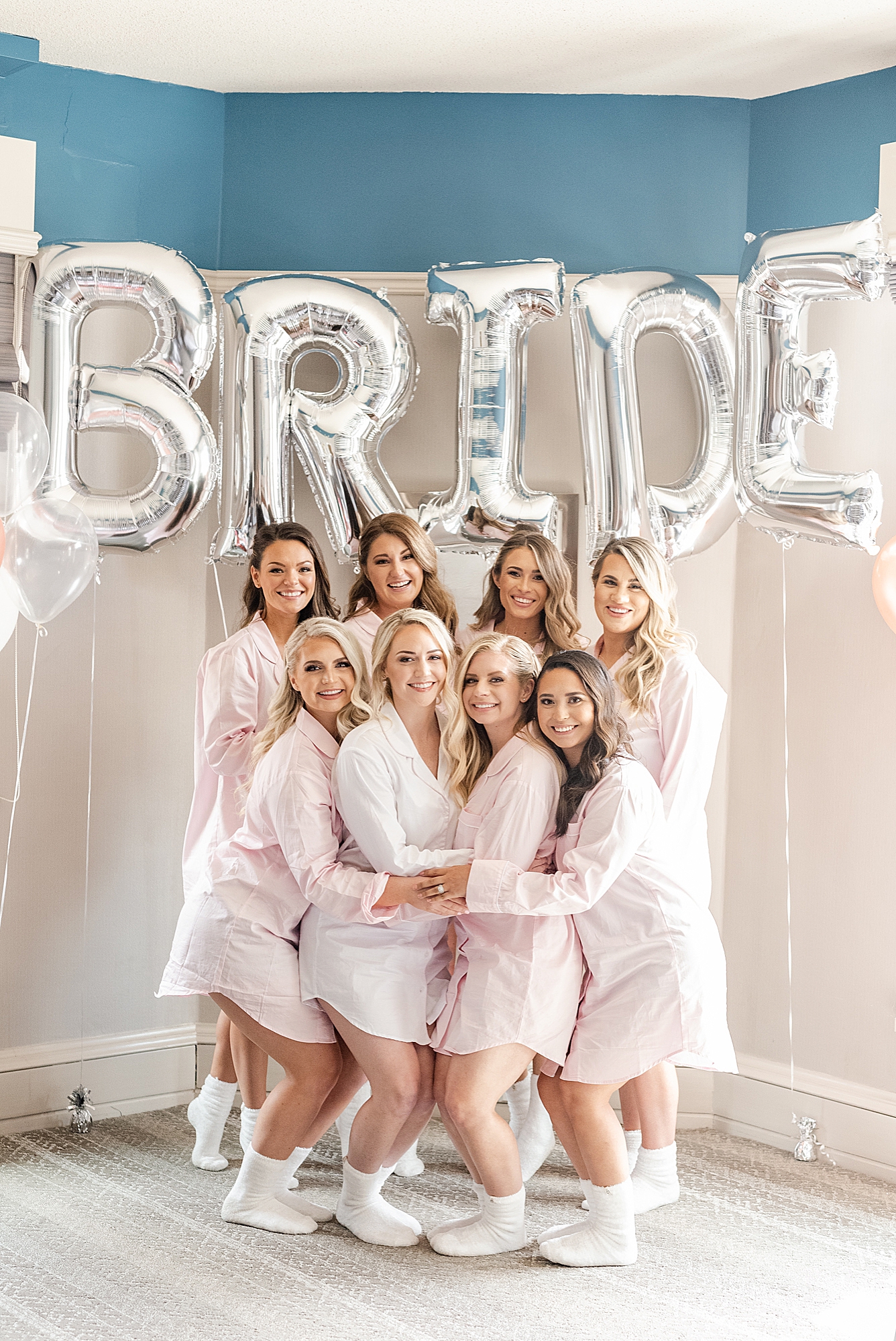 bride and bridesmaids pose by BRIDE balloons